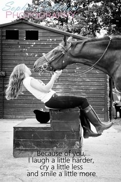 black and white photograph of a woman sitting on a box next to a horse