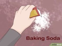 a hand holding a baking soda can with the words baking soda written below it in red and yellow