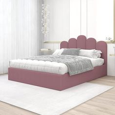 a pink bed sitting on top of a white rug