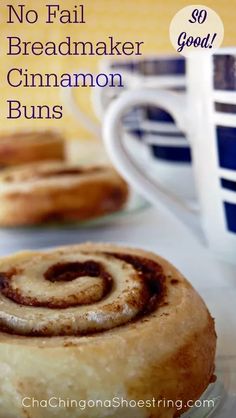 cinnamon buns on a plate next to a cup and saucer with the words no fail breadmaker cinnamon buns