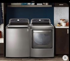 the front load washer and dryer are next to each other in this kitchen