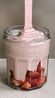 a spoon sticking out of a jar filled with food