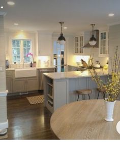 a kitchen with an island and wooden floors