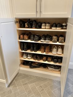 a white cabinet filled with lots of shoes