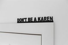 a sign that says don't be a kareen on the side of a door