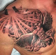 a man's chest with an eagle and cross tattoo design on the top half