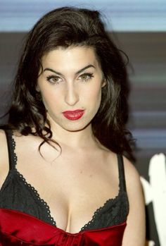 a woman with dark hair wearing a red and black bra