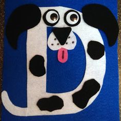 a blue and white dog with black spots on it's face is shown in the shape of a letter d