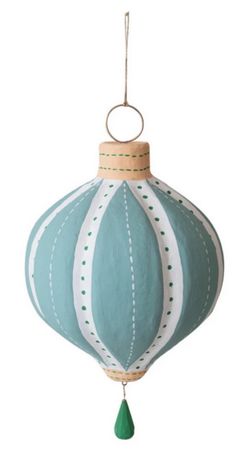 a blue and white ornament hanging from a string