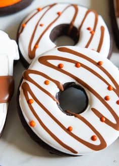 there are three donuts with chocolate icing on them