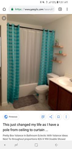 a bathroom with a toilet, sink and shower curtain in it's center area