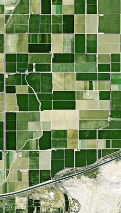 an aerial view of green fields and roads