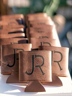 leather nameplates are lined up on top of each other for guests to sign