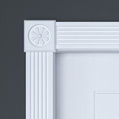 a white door with an ornate design on the front and side panel, against a gray background