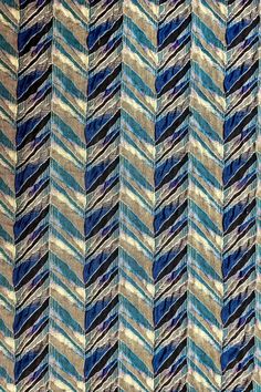 a close up view of a multicolored fabric with wavy lines and diagonal stripes