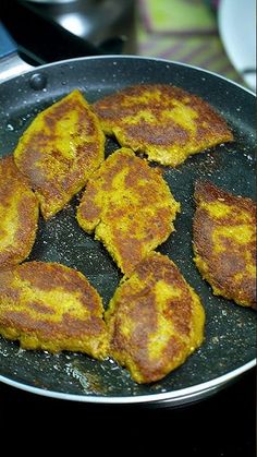 some food is being cooked in a pan on the stove top and ready to be eaten