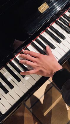 someone is playing the piano with their hands