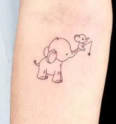 an elephant with a balloon tattoo on the arm