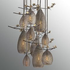 a chandelier with five hanging lights and several bulbs in the shape of tears