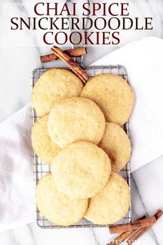 chai spice snickkerdoodle cookies on a cooling rack with cinnamon sticks