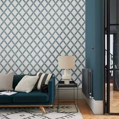 a living room with a blue couch and white rug