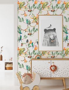 a child's room decorated with colorful wallpaper