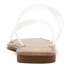 a woman's white sandal with clear straps