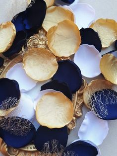 some blue and white flowers on a gold plate