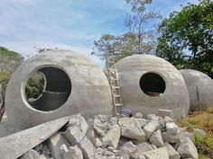 there are three cement structures made to look like they have been built into the ground