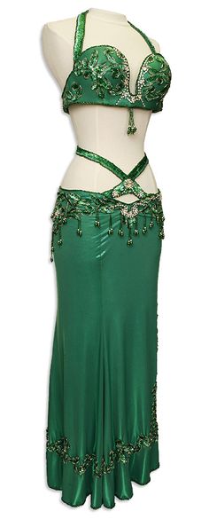 a woman wearing a green belly dance outfit with beading on the bust and skirt