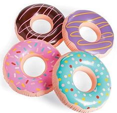 three donuts with sprinkles on them sitting next to each other in front of a white background