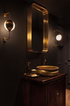 a bathroom with black walls and gold fixtures