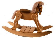 a wooden rocking horse with fur on it