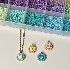 beads and charms are arranged in bins on a table with the letters e, f, c