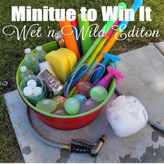 a bucket filled with lots of assorted items on top of a cement slab in the grass