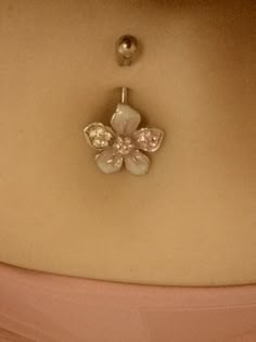 a woman's stomach with a flower shaped brooch