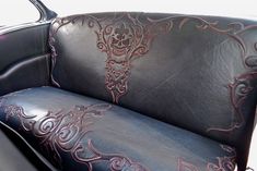 a black leather car seat with a skull on it