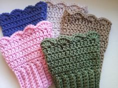 four crocheted oven mitts sitting on top of a counter