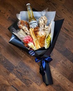 a bottle of beer sitting on top of a table next to some food and candy