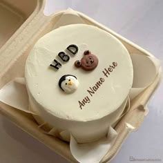 a cake in a box with two bears and a snowman on the top that says h b d any name here