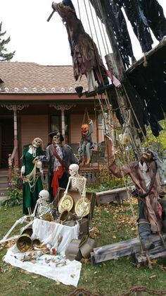 a group of people dressed up in halloween costumes on a porch next to a house