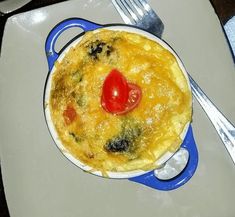 an omelet on a plate with a fork and knife