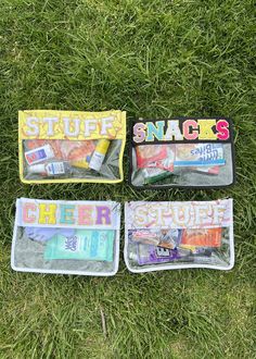 three clear bags filled with various items laying on the grass