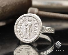 925 Silver Ancient Greek Coin Woman Signet Ring Handmade Anti-Tarnish Unique Dainty Ring Mythological Gift Fancy Lady Design Art Ring ⭐3 YEAR GUARANTEE FOR ANTI-TARNISH⭐ 💍Item Details💍 SKU CODE: ACRIT2031 ★ Material: 925 Sterling Silver (Rhodium Plated) ★ Silver Weight: App. 5.65 Grams {6 USA Size] ★ Ring Diameter: 2,3-2,7 mm ★ Ring Size: Available in variations  ★ Coin: Woman Portrait ★ Coin Size: 15X15,20 mm ★ Coin Metarial: 925 Sterling Silver (Rhodium Plated) ★ Ring Plate: Available in var Artisan Rings With Oxidized Finish For Anniversary, Artisan Oxidized Finish Rings For Anniversary, Silver Stamped Jewelry With Round Band, Stamped Silver Round Band Jewelry, Heirloom Sterling Silver Rings, Stamped, Heirloom Sterling Silver Ring With Stamped Details, Heirloom Sterling Silver Stamped Rings, Artisan Sterling Silver Signet Ring, Handmade Silver Signet Ring Fine Jewelry