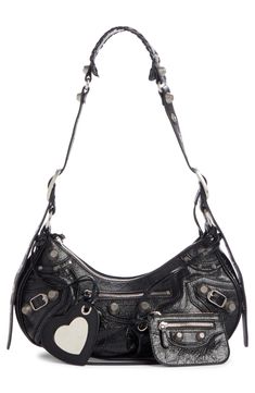 Balenciaga reimagines an '00s style with this hemispherical shoulder bag crafted from supple lambskin leather and detailed with textured hardware. A tasseled zipper pull, heart-shaped mirror bag charm and zip pouch complete the look with signature flair. 12"W x 7"H x 5"D. (Interior capacity: medium.)
9"– 22" convertible strap drop.
Pouch: 4"W x 3"H x 1/4"D.
1.2lb. Top zip closure Adjustable shoulder strap Exterior zip pockets Interior zip pocket Removable mirror and zip pouch Cotton canvas linin Designer Leather Hobo Bag With Branded Hardware, Designer Soft Leather Hobo Bag, Designer Leather Hobo Bag With Silver-tone Hardware, Designer Hobo Bag With Silver-tone Hardware, Designer Shoulder Bag With Gunmetal Hardware, Mirror Bag, Feeling Silly, Y2k Bags, 00s Style