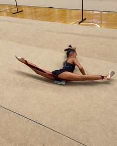 a woman laying on the ground with her legs spread out and one leg in the air