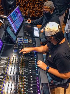 two men sitting at a sound mixing desk