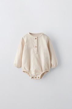 PLAIN BUTTONED BODYSUIT - Light beige | ZARA United States Beige Long Sleeve Cotton Onesie, Cotton Long Sleeve Onesie With Buttons, Cotton Long-sleeve Onesie With Buttons, Long Sleeve Cotton Onesie With Buttons, Solid Cotton Long Sleeve Bodysuit, Long Sleeve Solid Cotton Bodysuit, Solid Long Sleeve Cotton Bodysuit, Cotton Long Sleeve Bodysuit For Playwear, Long Sleeve Cotton Bodysuit For Playwear