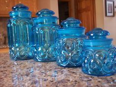 blue glass jars are lined up on the counter