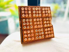 a close up of a wooden board game with numbers on the front and back sides